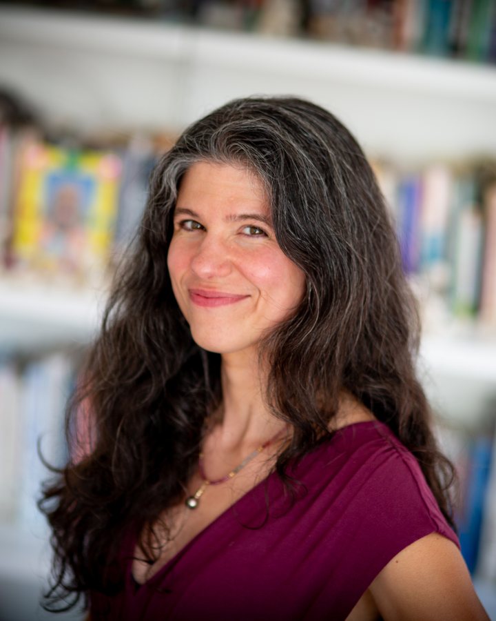 Eve Stoller, Clinical Social Worker, smiling in front of a bookshelf